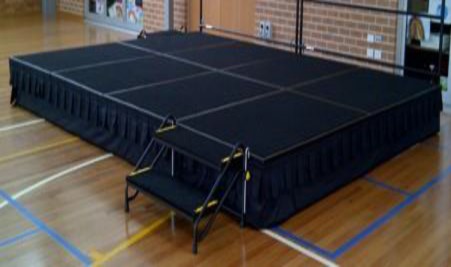 A black rectangular platform with black cloth  Description automatically generated with medium confidence