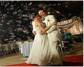 A person and person dancing at a wedding  Description automatically generated