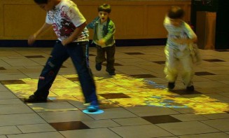 A group of kids playing with a game  Description automatically generated