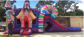 A inflatable slide with a large candy and a large inflatable slideDescription automatically generated with medium confidence