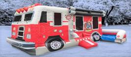 A inflatable firetruck in the snowDescription automatically generated
